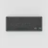 Clavier compact sans fil gris graphite à touches noires sans inscription, vu de dessus sur fond gris clair