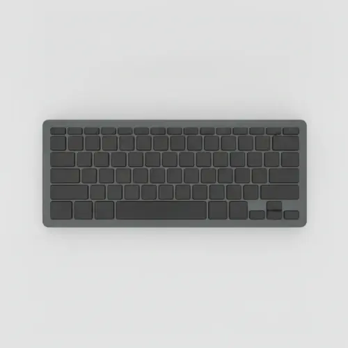 Clavier compact sans fil gris graphite à touches noires sans inscription, vu de dessus sur fond gris clair