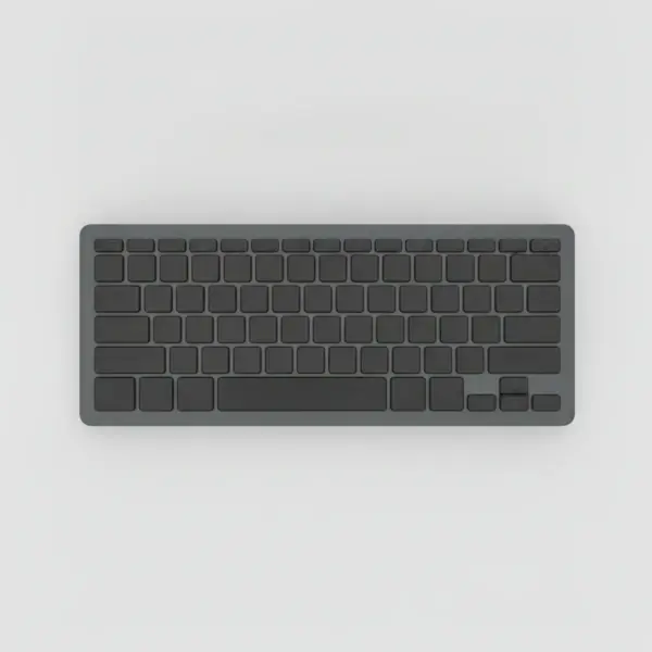 Clavier compact sans fil gris graphite à touches noires sans inscription, vu de dessus sur fond gris clair